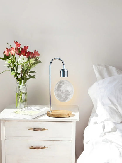 Lamp on a nightstand next to a vase of flowers in a bedroom setting